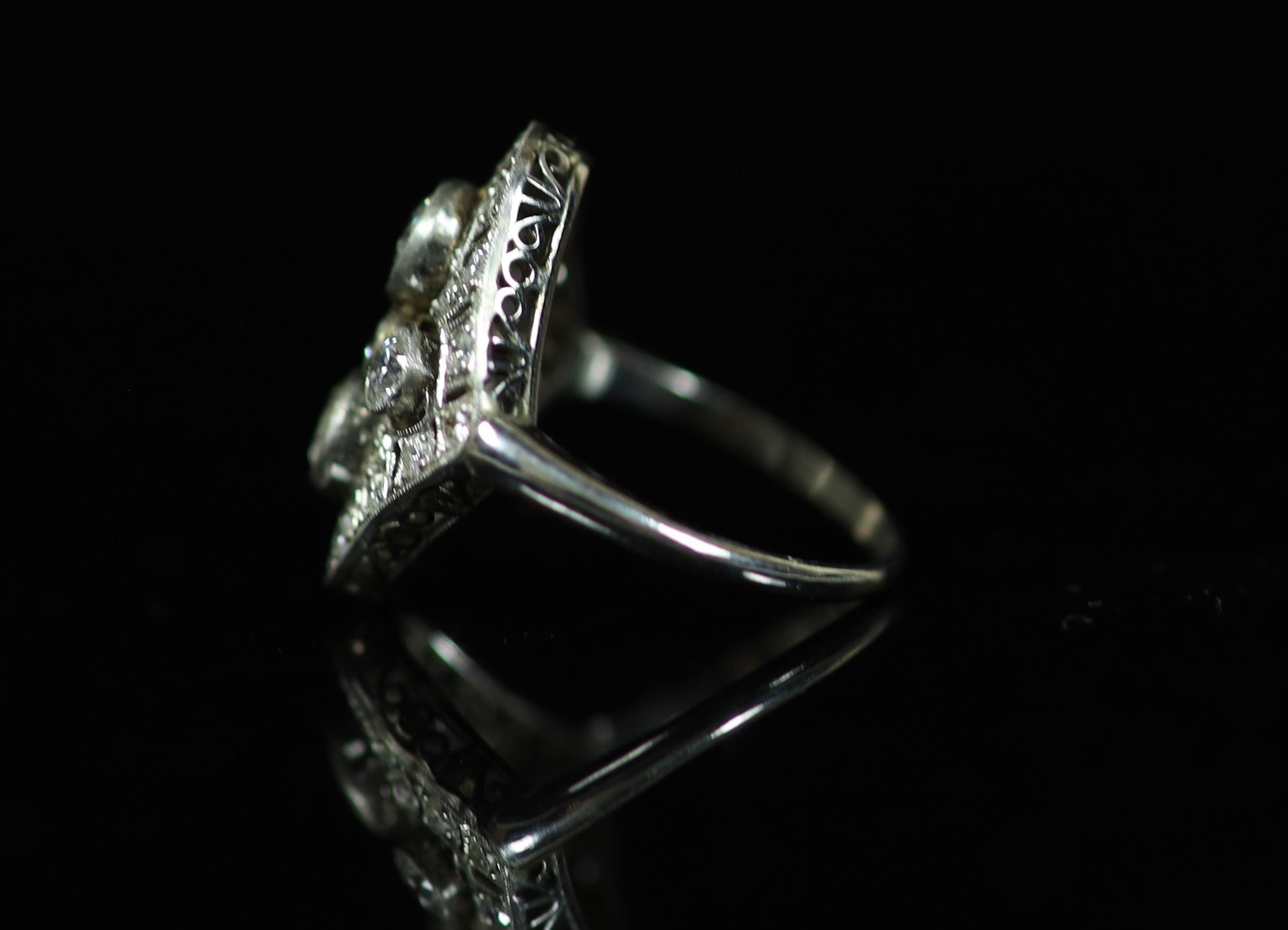 A 1930's/1940's platinum and millegrain set diamond cluster dress ring